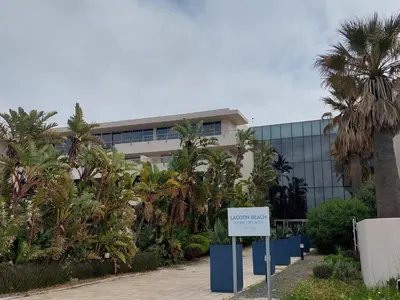 a building with a sign in front of it at Cape Beach Penthouse in Cape Town