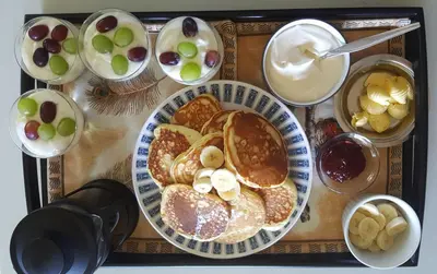 a table with a plate of pancakes and other breakfast foods at Durbanville Place - 3 bedroom apartment in Durbanville