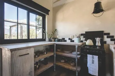 a kitchen with a counter and a stove and a window at The Farmstead in Franschhoek