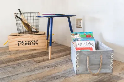 a blue table with a bag of food and a box of books at The Farmstead in Franschhoek