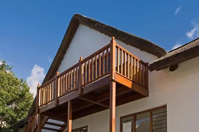a deck on the side of a house at Pacem cottage in Hermanus