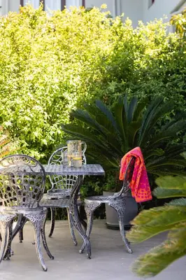 a table and two chairs and a table with a red towel at Protea & Pincushion Cottages in Hermanus