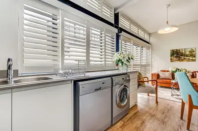 a kitchen with a dishwasher and a sink in a room at Eikehoff 25 in Stellenbosch