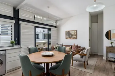 a kitchen and living room with a table and chairs at Eikehoff 25 in Stellenbosch