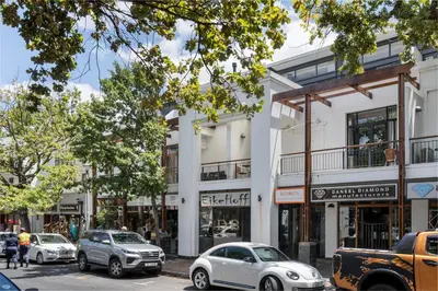 a street with cars parked in front of a building at Eikehoff 25 in Stellenbosch