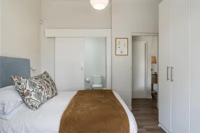 a bedroom with a bed with a pillow on it at Eikehoff 25 in Stellenbosch