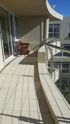 a porch with a bench on a house at A310 Lagoon Beach Apartment & Spa in Cape Town