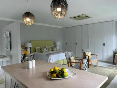 a bedroom with a bed and a table with a plate of fruit at Camberley Wines - Luxury Accommodation in Stellenbosch