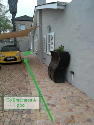 a yellow car is parked next to a building at Posto Al Sole - IL Bacio in Bellville
