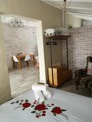 a bedroom with a bed with red flowers on it at Posto Al Sole - IL Bacio in Bellville