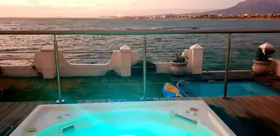 a bath tub on the deck of a cruise ship at Westbank Private Beach Villa, 4 Bedrooms, Private pool, on the Beach! in Gordonʼs Bay