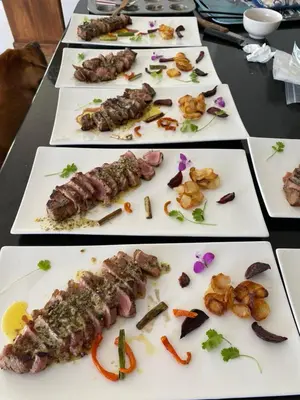 a table with several different types of food on plates at Peach on Beach Boutique Guesthouse in Bloubergstrand