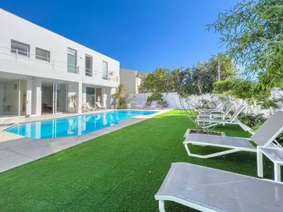 an image of the backyard of a house with a swimming pool at Peach on Beach Boutique Guesthouse in Bloubergstrand