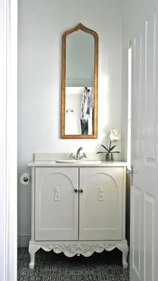 a white bathroom with a sink and a mirror at Daisy Place in Franschhoek