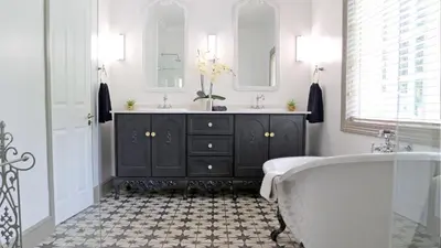 a bathroom with a tub and a sink at Daisy Place in Franschhoek