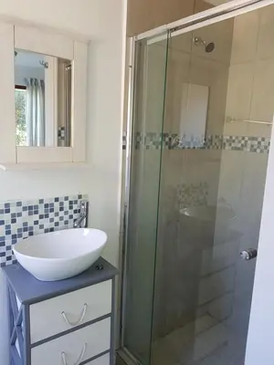 a bathroom with a sink and a shower at Drommedaris in Gordonʼs Bay