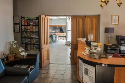 a restaurant with a counter and a room with a hallway at Ramasibi Guest Services in Panorama