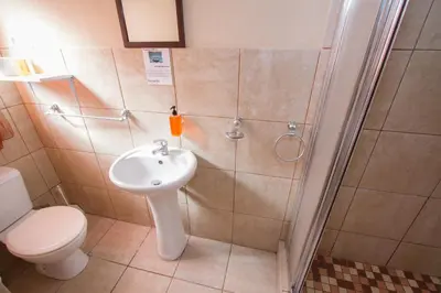 a bathroom with a toilet and a sink at Ramasibi Guest Services in Panorama