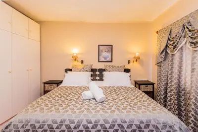 a bedroom with a bed with two pillows on it at AJEE B&B in Paarl