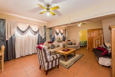 a living room with a couch and a table at AJEE B&B in Paarl