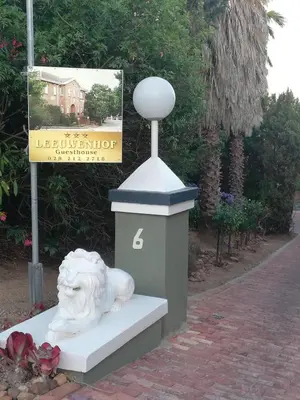 a statue of a lion sitting on a bench at Leeuwenhof Guesthouse in Caledon