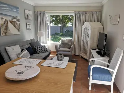 a living room with a couch and a table at On Cloud 9 in Hermanus