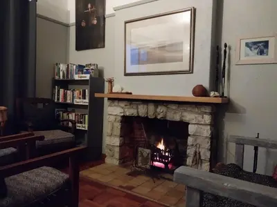 a fireplace in a living room with a fire place at The Trailhouse - Betty's Bay in Bettyʼs Bay