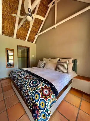 a large bed in a room with a ceiling at Rivers Own Guest Lodge in Breerivier