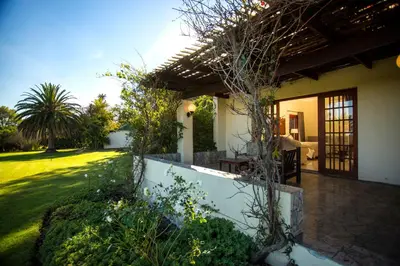 a house with a patio and a garden at The Country Guesthouse in Stellenbosch