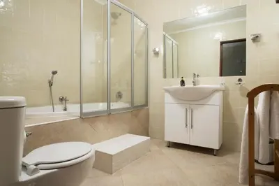 a bathroom with a toilet and a sink and a shower at The Country Guesthouse in Stellenbosch