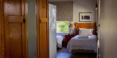 a bedroom with two beds and a window at Westbury House Guest House in Cape Town