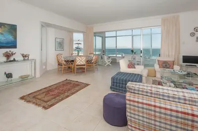 a living room with a view of the ocean at Jewel of Bayview in Hermanus