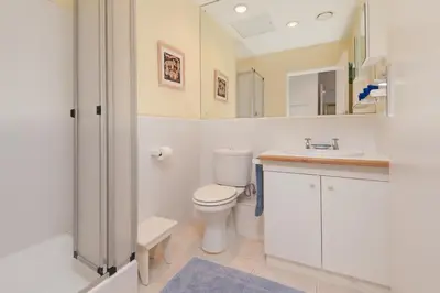a bathroom with a toilet and a sink at Jewel of Bayview in Hermanus