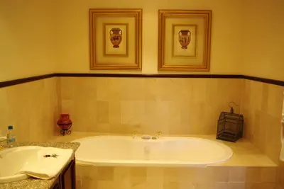 a bathroom with a tub and a sink at Lyngrove Wines & Guesthouse in Stellenbosch