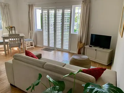 a living room with a couch and a dining room at Anchor's Rest in Hermanus