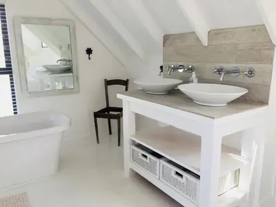 a white bathroom with two sinks and a mirror at Pringle @ 865 Jally in Pringle Bay