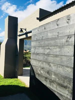 a wooden door to a house with a fence at Pringle @ 865 Jally in Pringle Bay
