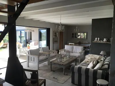 a living room with couches and chairs and a table at Pringle @ 865 Jally in Pringle Bay