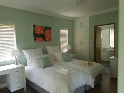 a bedroom with a white bed with two towels on it at Besigheim in Stellenbosch