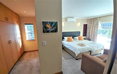 a hotel room with a bed and a chair at Besigheim in Stellenbosch