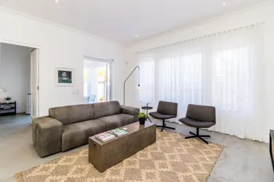 a living room with a couch and two chairs at Perla in Hermanus
