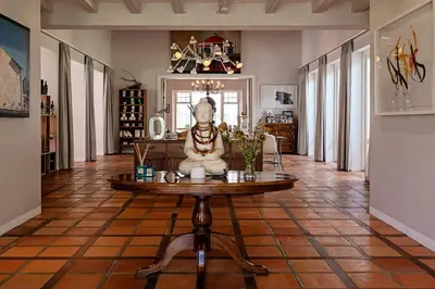 a room with a table with a statue on it at Holden Manz Country House in Franschhoek