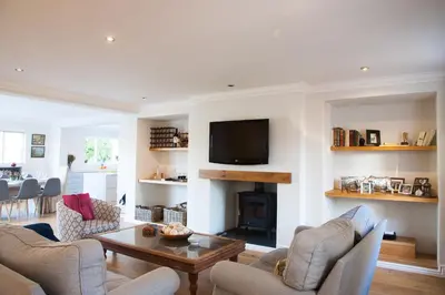 a living room with a fireplace and a tv at Charming Villa in Stellenbosch