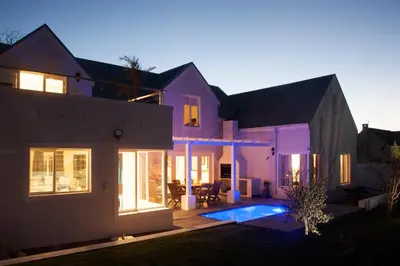 a house with a swimming pool in front of it at Charming Villa in Stellenbosch