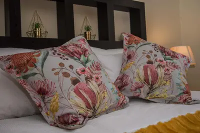 a bed with two pillows on top of it at Ocean View Luxury Self-Catering in Strand