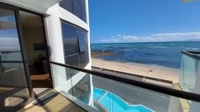 a balcony with a view of the ocean at Ocean View Luxury Self-Catering in Strand