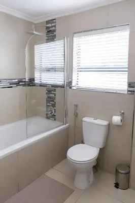 a bathroom with a toilet and a tub and a shower at MLMK Property 30 in Richwood