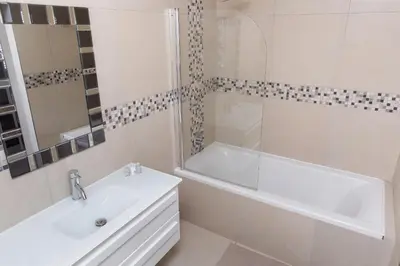 a white bathroom with a sink and a bath tub at MLMK Property 30 in Richwood