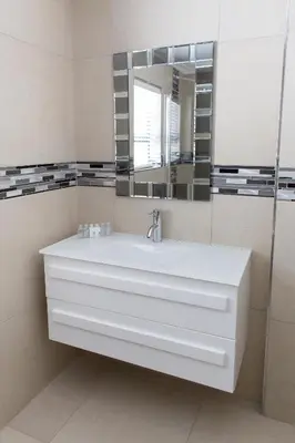 a bathroom with a white sink and a mirror at MLMK Property 30 in Richwood