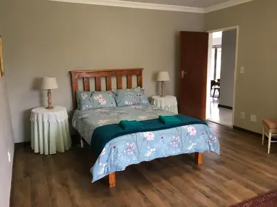 a bedroom with a bed and two tables with lamps at 18 Patrys Crescent in Hermanus